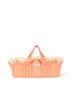 The Konges Sloejd Doll Lift - Rose Dot is a peach-hued quilted cotton baby basket featuring white polka dots, scalloped edges, two convenient handles, and a small label on the front. OEKO-TEX certified for safety and comfort, this delightful doll carrier is shown empty against a white background.