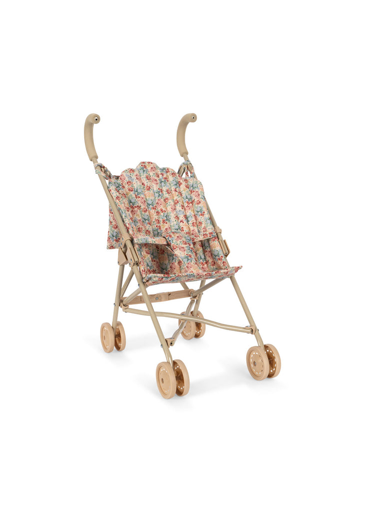 The Konges Sloejd Doll Stroller - Vienna features curved handles, beige and gold accents, floral-patterned removable fabric, and four double gold wheels, shown against a plain white background.