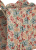 Close-up of the Konges Sloejd Doll Stroller - Vienna’s quilted fabric, featuring a red, blue, green, and pink floral pattern with vertical stitching and scalloped top edges—ideal for lining a carriage bag or doll stroller.