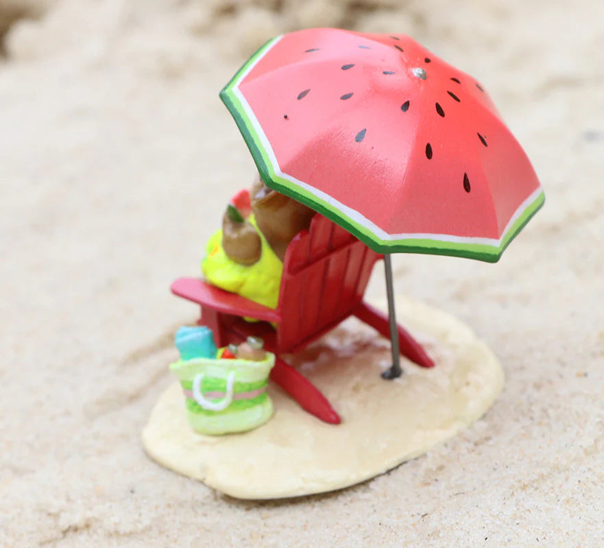 A Wee Forest Folk Tiny Collectible - Perfect Beach Day! features a hand sculpted mouse on a red chair under a watermelon-patterned umbrella with a striped beach bag, all set on light sand.