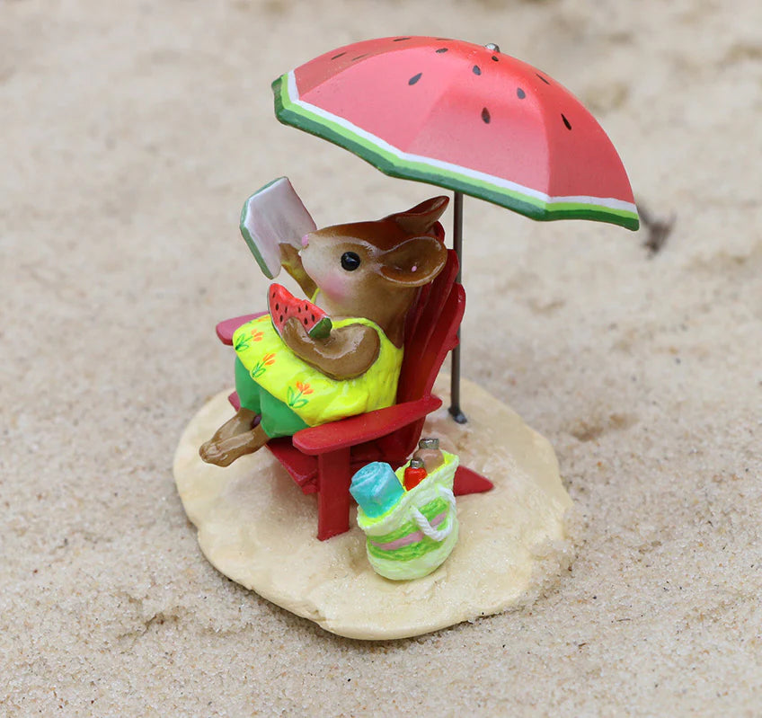 The Wee Forest Folk Tiny Collectible - Perfect Beach Day! features a rabbit in a yellow dress on a red chair under a watermelon umbrella, holding watermelon with a green bag on sand—capturing the charming beach scene.