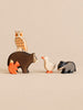 A wooden owl perched on a bear, with a squirrel, a duck, and a badger standing nearby as part of a Handmade Holzwald Woodland Animals Set.