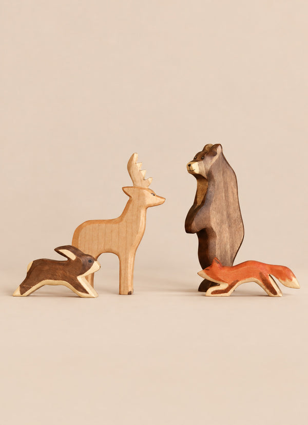 Handmade Holzwald Woodland Animals set featuring wooden bear, deer, fox, and rabbit toys standing on a neutral surface.