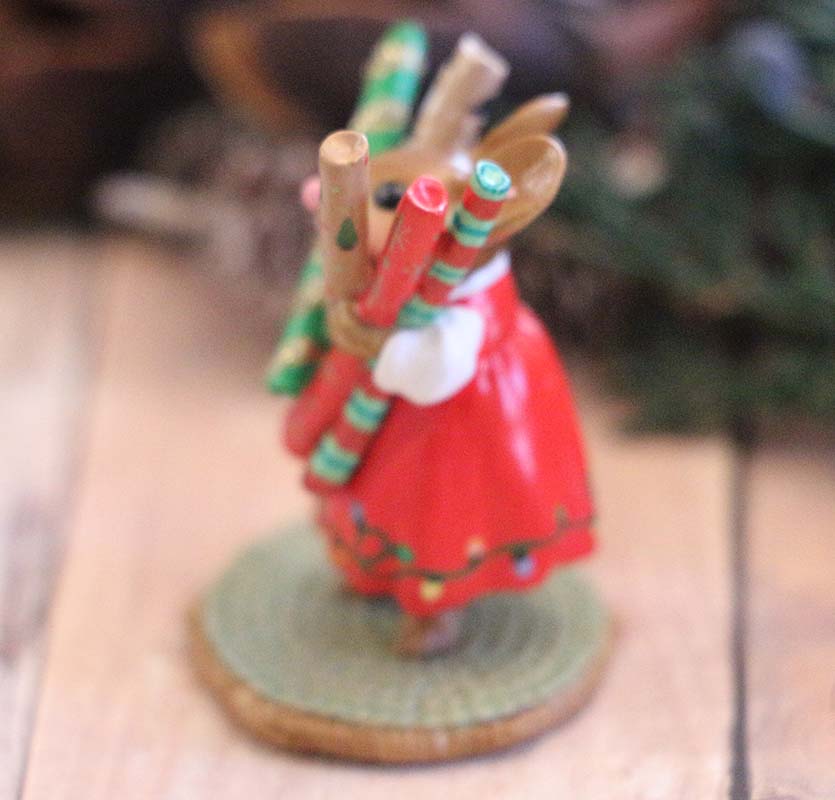 The Wee Forest Folk Tiny Collectible - Wrap it Up! (Not a Toy) features a bunny in a red dress on a textured base, holding green and red striped objects, perfect for collectors seeking charming miniatures.