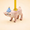 Add a touch of whimsy to any celebration with the Pig Cake Topper – Final Sale. This charming handcrafted collectible features a small pig wearing a blue and white striped party hat and carrying a yellow candle on its back, set against a plain beige background. Perfect as a keepsake birthday decoration!.