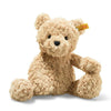 A Steiff, Jimmy Teddy Bear, 12 Inches with light brown fur, black eyes, and a nose,sitting upright against a white background. It has a Steiff label on its ear.