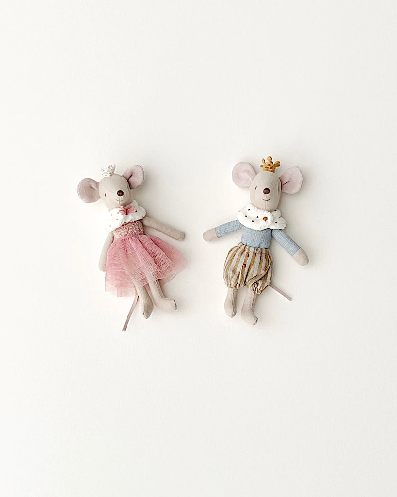 Two Maileg Royal Mice figurines, dressed in fabric outfits, one in a pink skirt and the other in striped pants, against a plain white background.