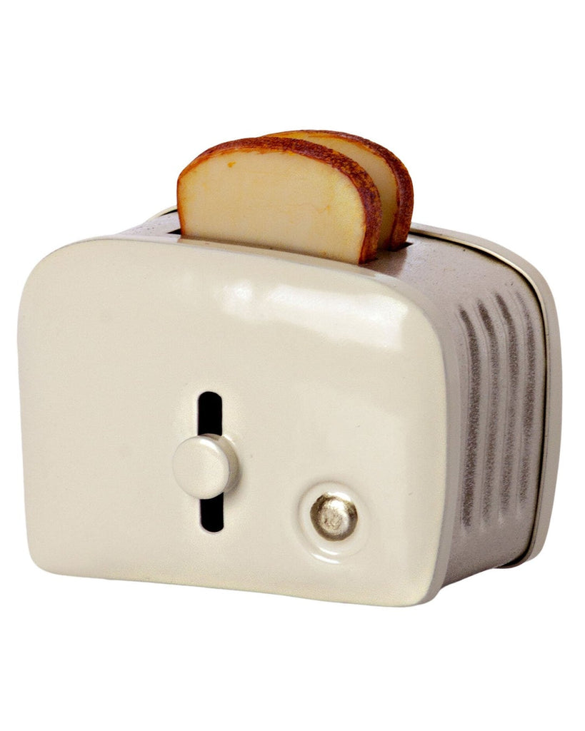A quirky Maileg | Miniature Toaster designed to look like a retro camera with a slice of toasted bread emerging from the top slot, resembling a photograph being developed.