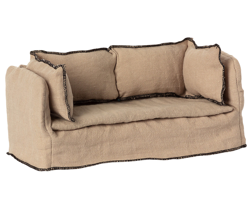 A plush beige linen Maileg | Dollhouse Couch-style dog bed with raised sides and decorative black stitching along the edges, isolated on a white background.