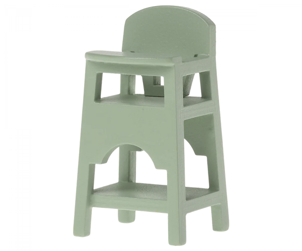 A light green Maileg Mouse Size wooden high chair with back support and footrests, isolated on a gray background.
