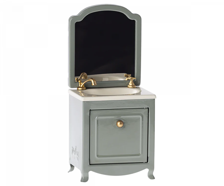 Vintage-style Maileg Miniature Sink With Mirror with a removable mirror, brass faucet, and a single cabinet, set against a transparent background.