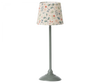 An elegant Maileg Miniature Floor Lamp - Tall with a floral patterned lampshade and a classic gray base, designed specifically for children's lighting, isolated on a black background.