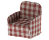 A cozy Maileg Plaid Chair upholstered in a red and white checkered fabric against a transparent background.