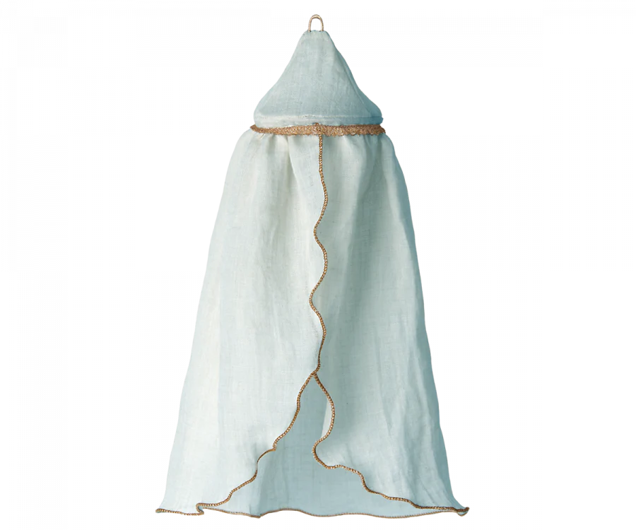 A Maileg Mini Bed Canopy with a conical top and flowing fabric, edged with brown trim, perfect for a whimsical bed decoration. It has a loop at the top for hanging from the bedroom ceiling and creates an airy look, ideal for draping over a bed or cozy nook. The fabric drapes elegantly to form a soft enclosure.