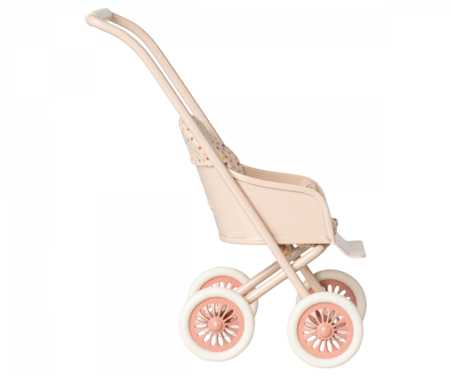 A side view of a Maileg Miniature Stroller, Micro - Powder with patterned fabric on the seat. It has large, round wheels also in light pink, and the handlebar is curved for easy pushing. The design and color scheme suggest it is made for young children.
