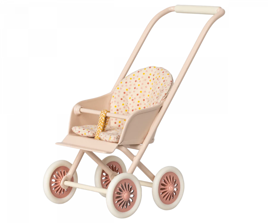 A Maileg Miniature Stroller, Micro - Powder with a light pink frame, four pink wheels, and a fabric seat featuring a polka dot pattern with various colors. The stroller has a handlebar for pushing and a safety belt with a yellow and white design.