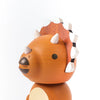 A wooden Triceratops bobblehead figurine with a round body and a smiling, head-shaking face, featuring prominent white-tipped spines and a two-tone brown color scheme.