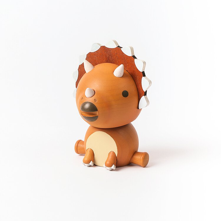 A wooden Triceratops bobblehead figurine with spikes tipped in white, featuring a playful, cartoon-like design on a plain white background.