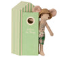 A Maileg Beach Mouse - Dad plush toy with a straw hat and plaid swim trunks, leaning against a green and white striped box labeled "beach house.