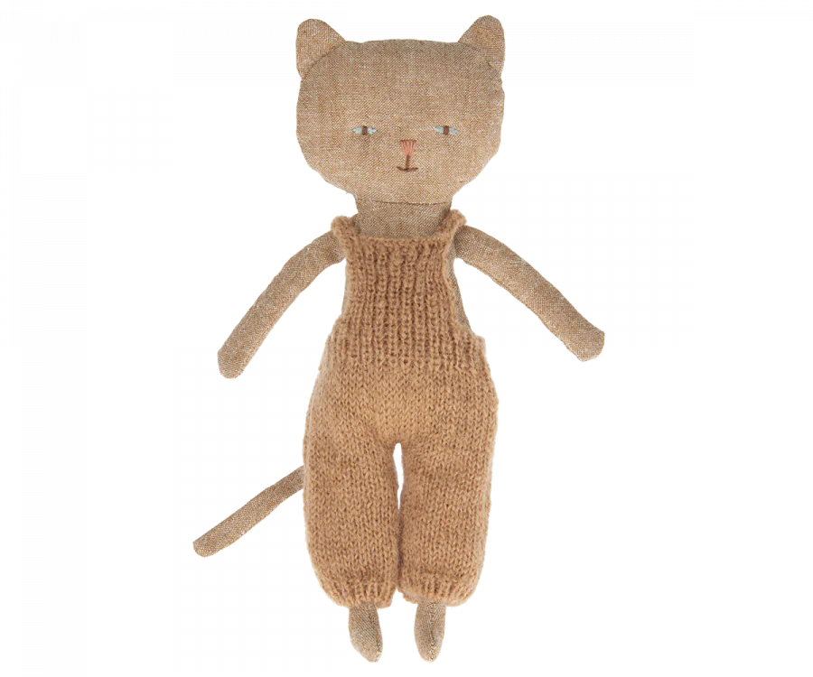 A worn, Maileg Cat Stuffed Animal with button eyes and a knitted overall, standing upright against a solid background.