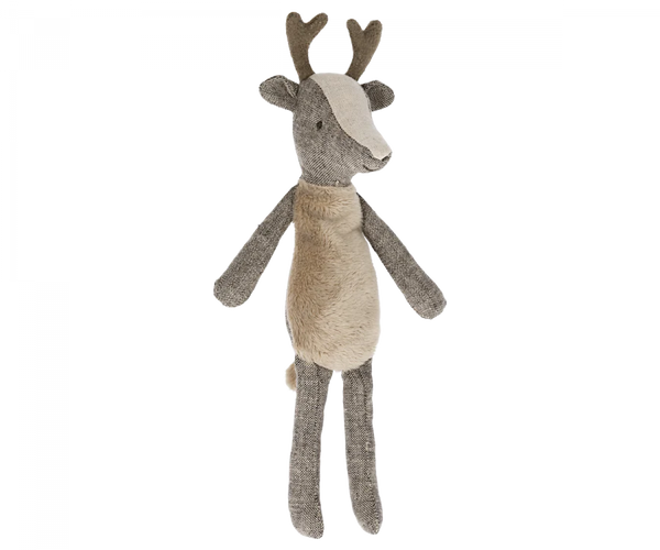 A small deer stuffed animal with antlers photographed on a flat background.