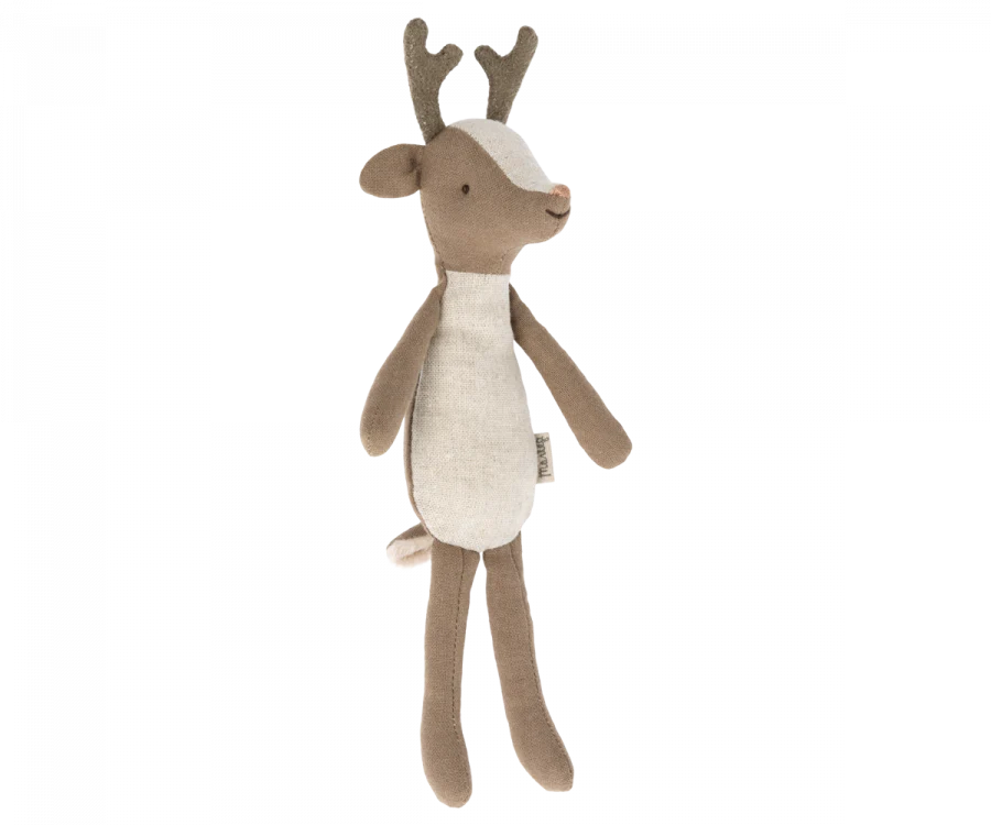 A small deer stuffed animal with antlers photographed on a flat background.