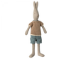 The Maileg Rabbit Size 3, Classic, stands upright as a charming bunny toy with long ears. This soft rabbit is made from natural linen and is dressed in a striped brown and white knit sweater along with teal shorts. Its minimalist facial features, including a small nose and eyes, add to its simple yet endearing look. Expand the wardrobe options available!