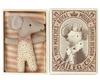 a small mouse doll inside a match box, with a blanket.