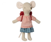 A Maileg Big Sister With Backpack - Red plush toy wearing a red and white checkered shirt, blue skirt, and standing upright against a black background.