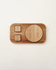 A Wooden Fraction Puzzle - Made in USA designed as a fraction puzzle, featuring pieces marked "1/2 + 1/2" on a round piece and two small squares on a rectangular base, set against a plain
