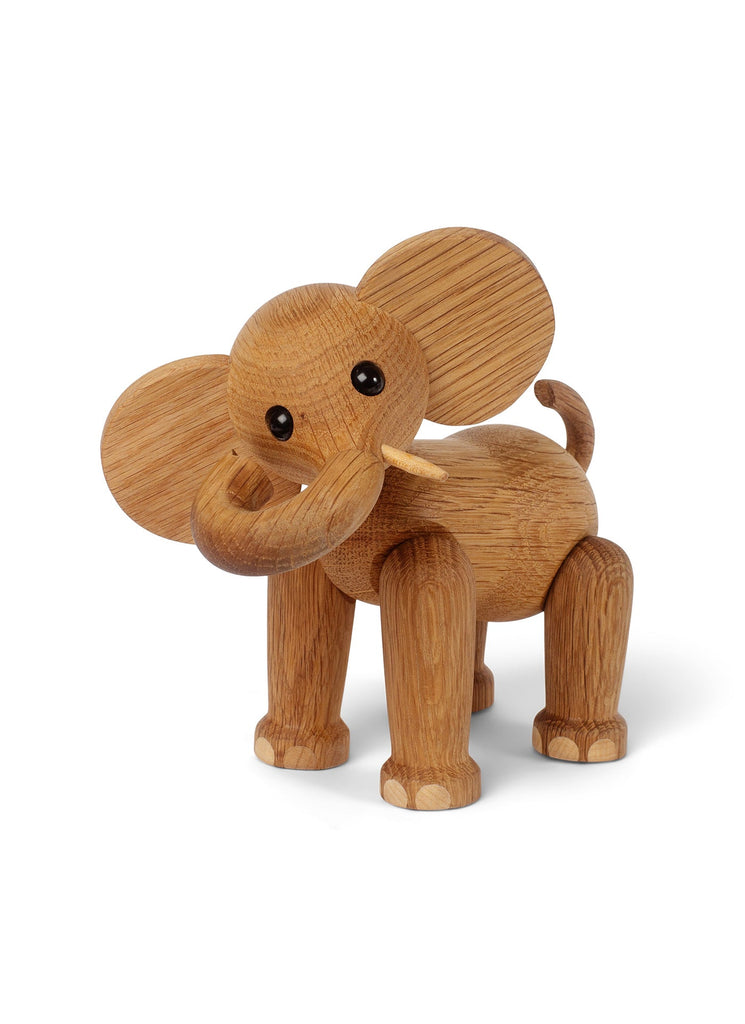 A Spring Copenhagen Ollie - Elephant figure with articulated joints and large, rounded ears, crafted from FSC Oak wood, standing against a white background.