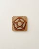 A wooden puzzle consisting of concentric geometric shapes on a pale background, showcasing a blend of artistic craftsmanship and simplicity. Made from beech and sapele wood. Shapes Stacking Toy