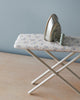 A small Maileg | Miniature Iron & Ironing Board with a floral pattern cover and a silver play iron placed on top, set against a neutral background.