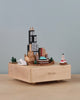 A Chicago Wooden Music Box featuring miniature landmarks of Chicago, including skyscrapers and a lighthouse, displayed on the music box base with "Chicago" labeled at the front.