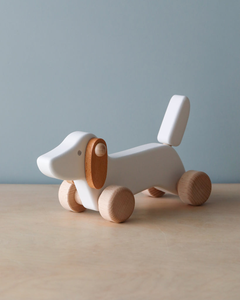 Wooden white dachshund dog push toy. 