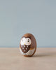 A Hand Painted Hollow Wooden Easter Egg - Owl painted to resemble a cute owl, with large eyes and detailed feather patterns, set against a pale blue background, perfect for hiding treasures.