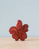 Handmade Holzwald Octopus octopus statue, painted red with decorative white dots, displayed against a light blue background.