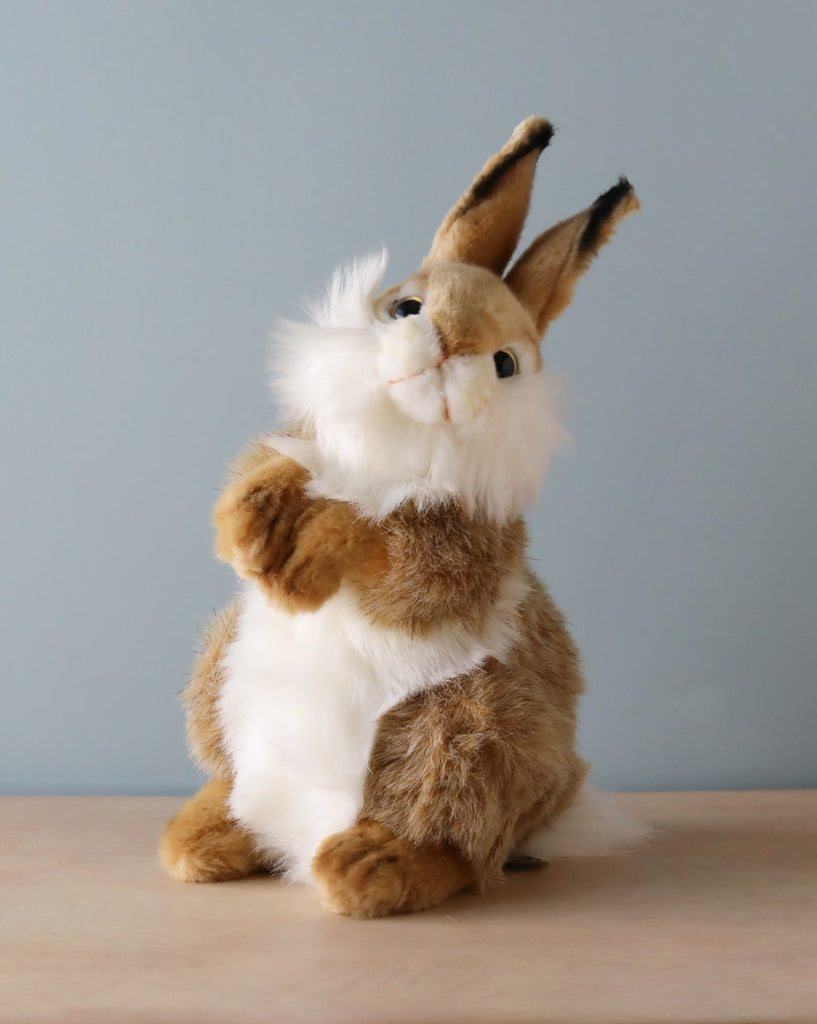 A Thumper Rabbit Stuffed Animal resembling a standing rabbit with long ears and fluffy white and brown fur, crafted from high-quality materials, displayed against a soft blue background.