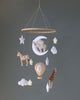 A Handmade Mobile - Day Dreamer - Final Sale featuring a wooden hoop from which plush toys are suspended, including a zebra, giraffe, elephant, hot air balloon, clouds, and stars against a grey background.