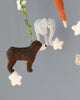 A Handmade Mobile - In The Jungle - Final Sale featuring a brown bear, a grey elephant, a white star, and a portion of an orange carrot, all suspended from strings against a light grey background.