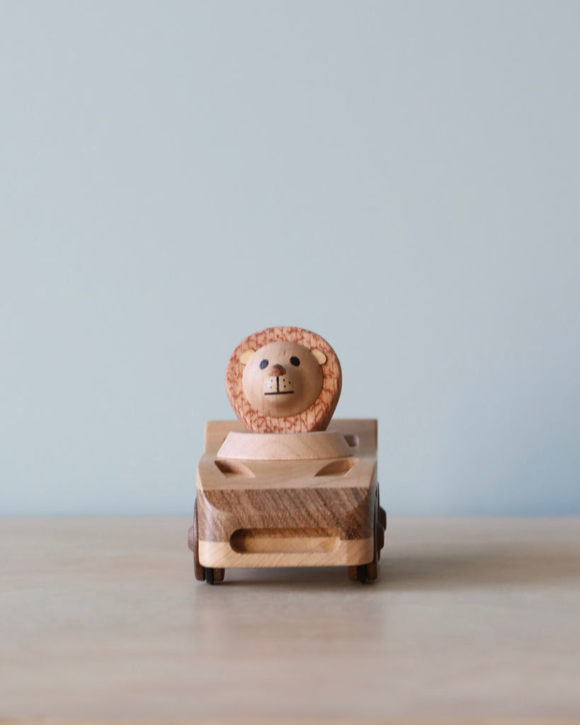 Wooden car toy with a lion as the driver. 