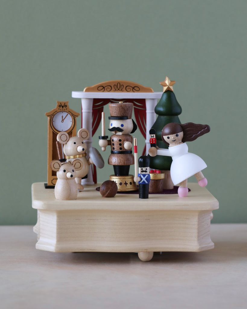 A Nutcracker Ballet Music Box from Wooderful Life featuring a nutcracker, a ballerina, and other charming figures like a bear and a clock, all crafted from sustainably sourced wood and set.