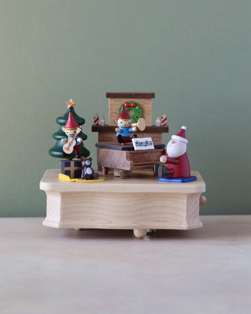 Christmas themed music box with Santa and elves playing music