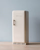 A Maileg Miniature Fridge with the brand name "maileg" on the door, featured against a soft blue background.