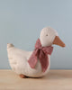 A Maileg Duck - Sand toy with a red and white checkered bow around its neck, perfect as festive décor, displayed against a neutral blue background.