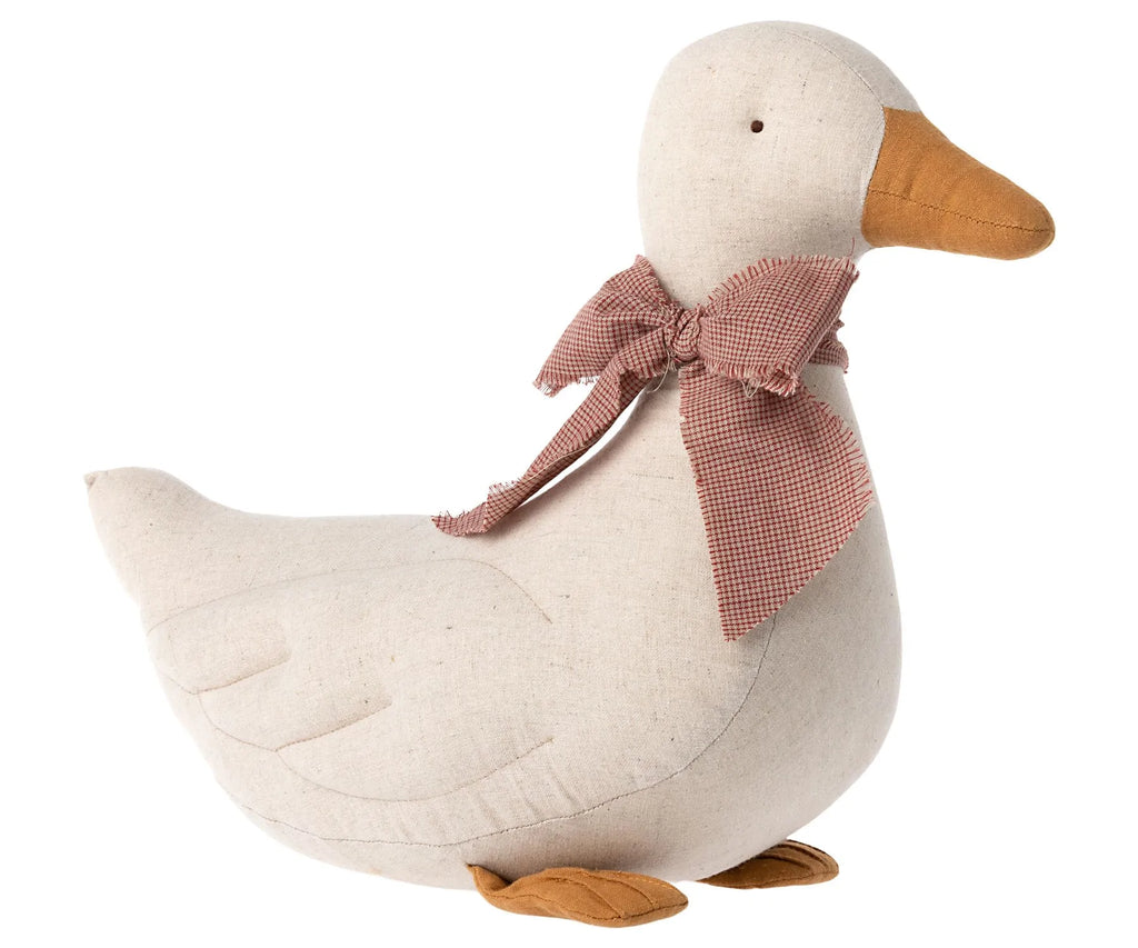 A Maileg Duck - Sand shaped decorative object with a beige body, orange feet, and wearing a plaid bow around its neck for the festive season, isolated on a white background.