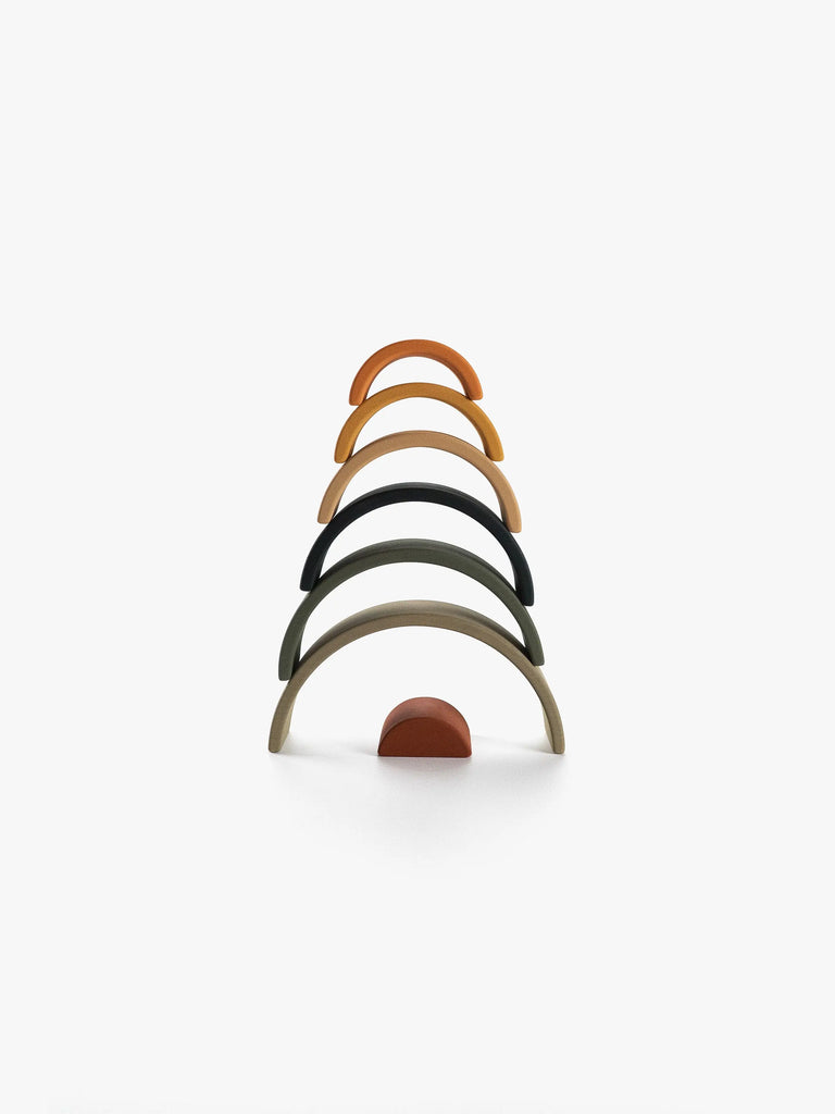 Image of a colorful handmade Handmade Mini Rainbow Stacker - Jungle toy in a rainbow shape, with arches arranged from largest to smallest, standing vertically against a white background.