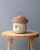 A natural color mushroom rattan basket on a chair. 