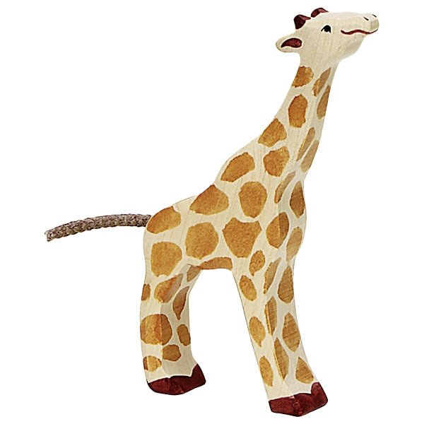 A Holztiger Small Feeding Giraffe from the HOLZTIGER figures collection, boasting a long neck, light brown body covered in darker brown spots, red-brown feet, and small horns on its head. Handcrafted wood details include a braided tail and a gentle, playful expression. Made in Europe.