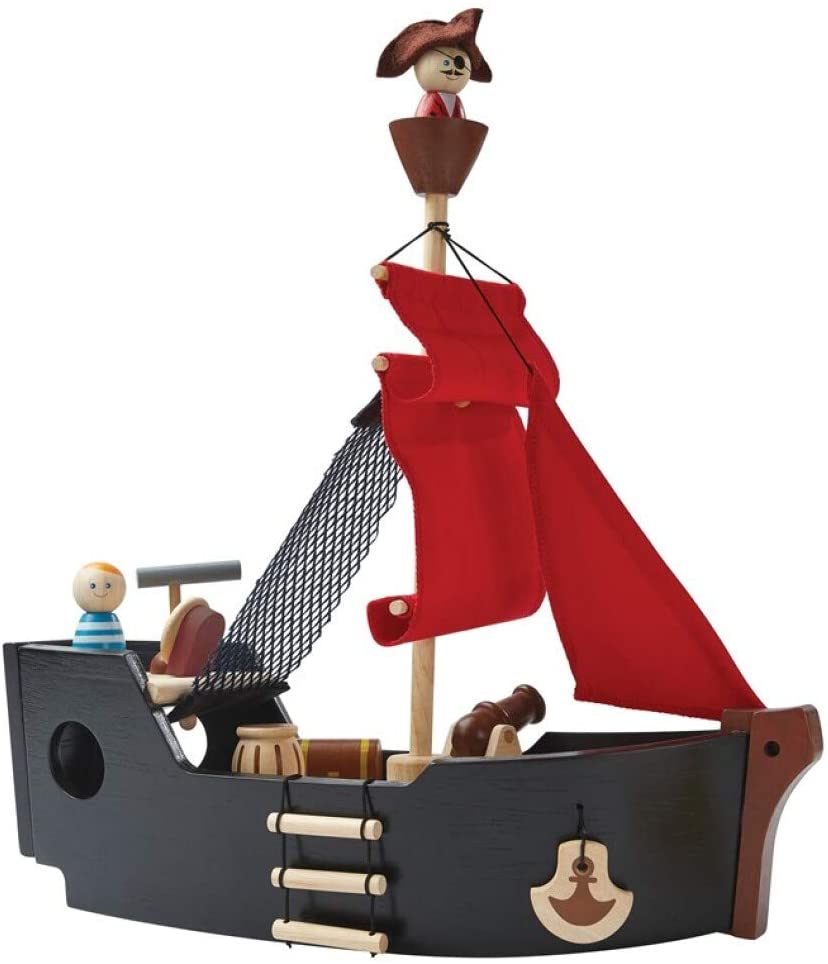 A wooden, non-toxic Pirate Ship Set featuring red sails, a smiling figurehead, and two cartoonish figures, one wearing a pirate hat, isolated on a white background.